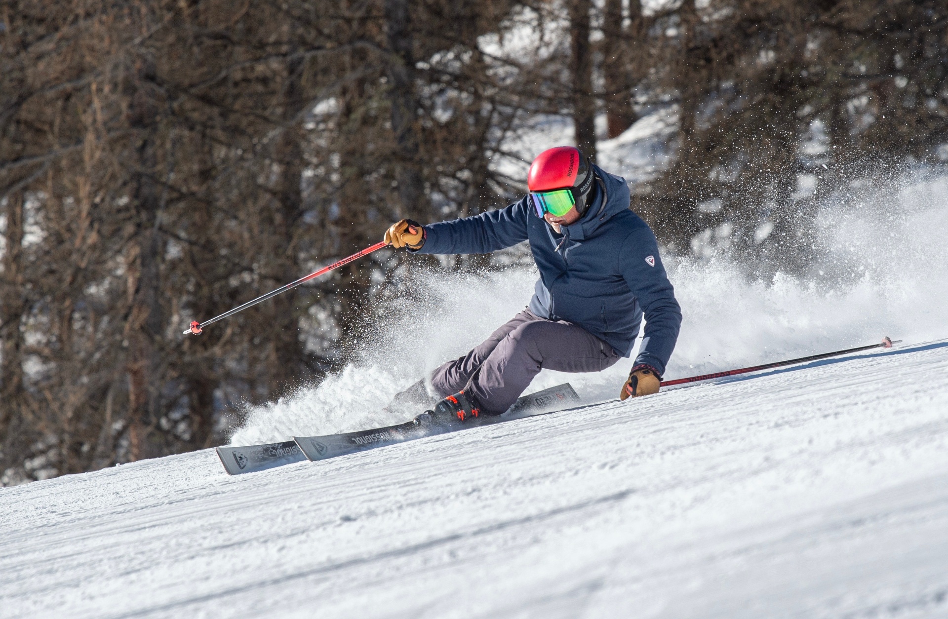 A relaxed skier making smooth parallel turns on a quiet piste.